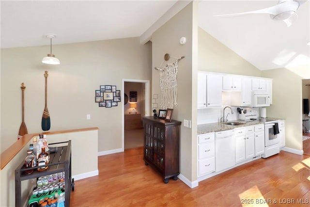 kitchen featuring light stone counters, light wood-style flooring, white appliances, a sink, and white cabinets