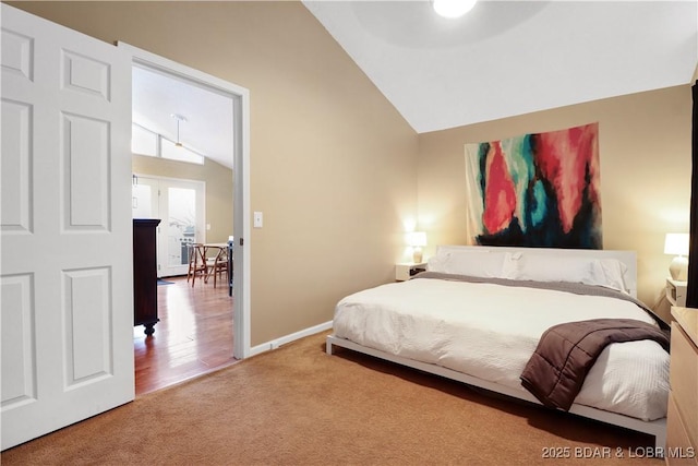 bedroom featuring lofted ceiling, carpet, and baseboards