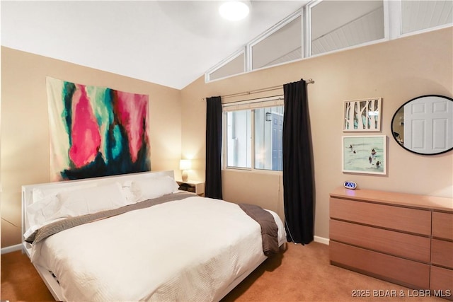 bedroom featuring lofted ceiling, light carpet, and baseboards