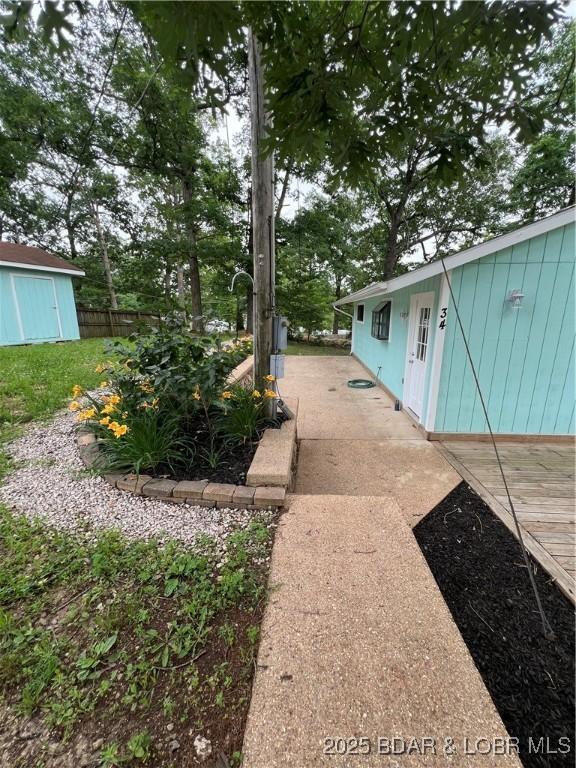 view of yard with an outdoor structure and fence