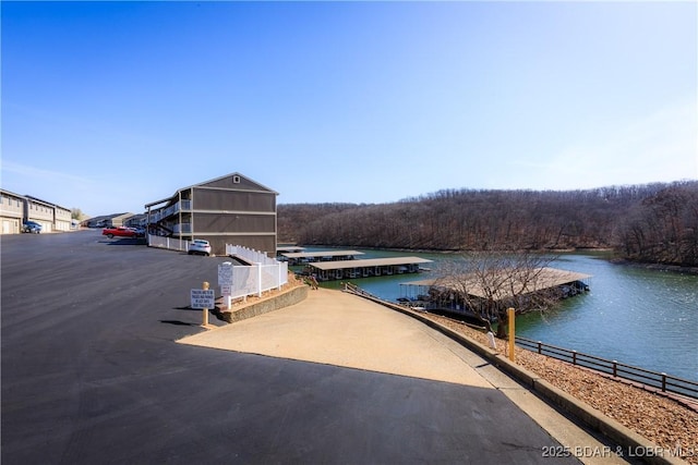 611 Lazy Days Rd Unit V-7, Osage Beach, MO 65065 - view of dock featuring fence, a forest view, and a water view