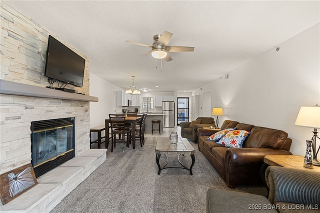 611 Lazy Days Rd Unit V-7, Osage Beach, MO 65065 - living room with light carpet, a ceiling fan, visible vents, and a fireplace