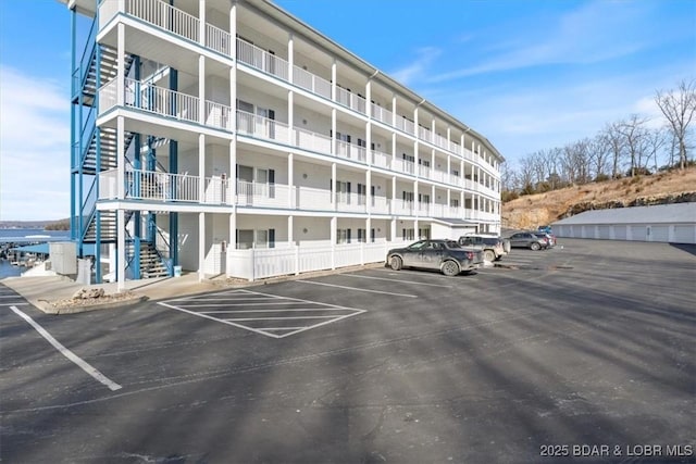 view of building exterior with uncovered parking