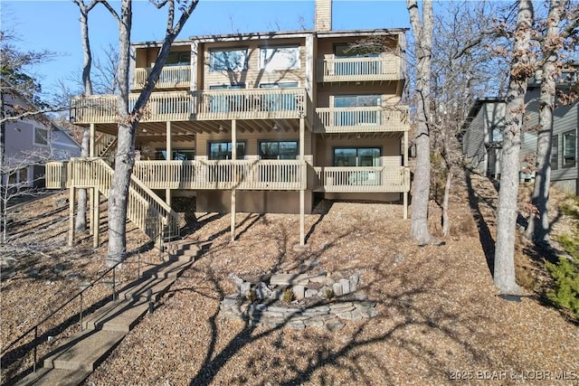 back of property with a chimney