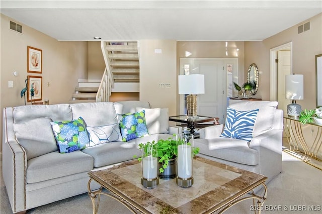 living room with visible vents and stairs