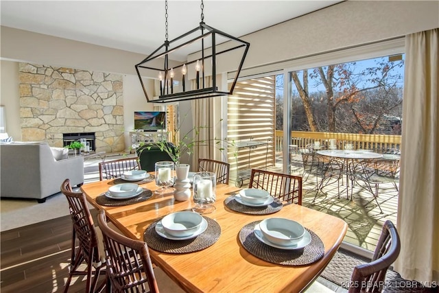 dining area featuring a fireplace and dark wood finished floors