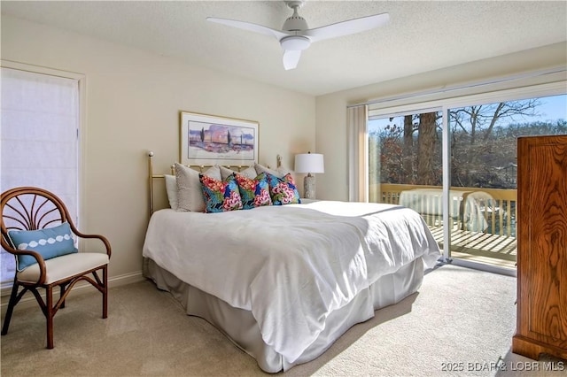 bedroom featuring a textured ceiling, light colored carpet, a ceiling fan, baseboards, and access to outside