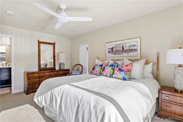 bedroom featuring carpet floors, connected bathroom, ceiling fan, and baseboards