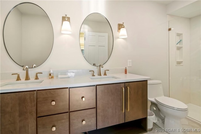 bathroom with toilet, double vanity, walk in shower, and a sink