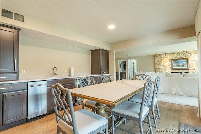 dining area with light wood-type flooring, visible vents, and recessed lighting