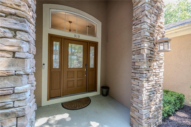 property entrance featuring stucco siding