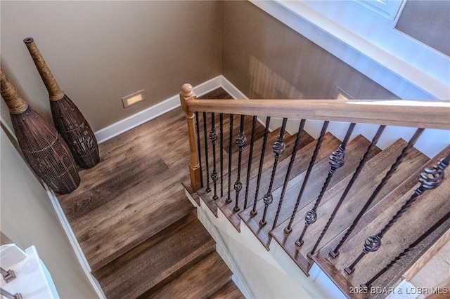 stairs with baseboards and wood finished floors