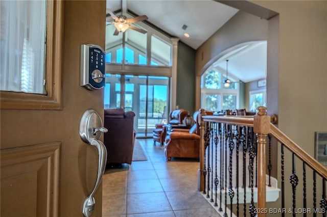 tiled entryway with vaulted ceiling and ceiling fan