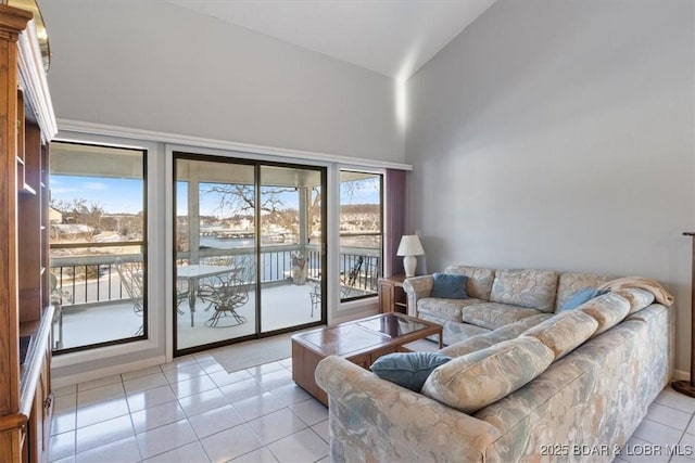 living room with light tile patterned flooring and a water view