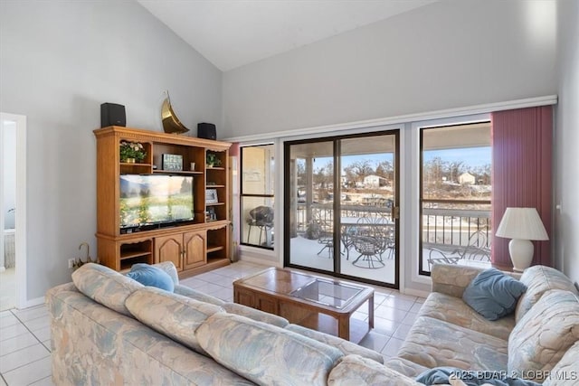 tiled living area with high vaulted ceiling
