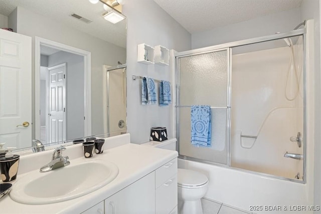 full bathroom with a textured ceiling, visible vents, enclosed tub / shower combo, toilet, and vanity