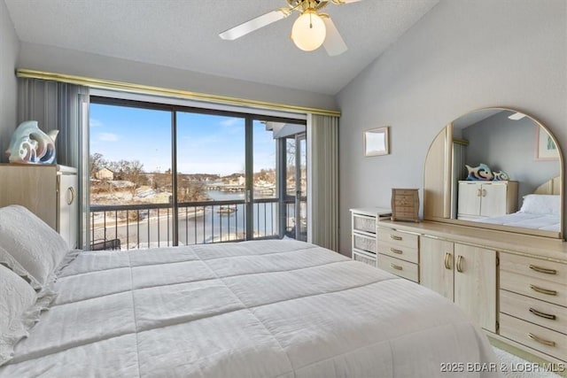 bedroom with access to outside, a water view, ceiling fan, and vaulted ceiling