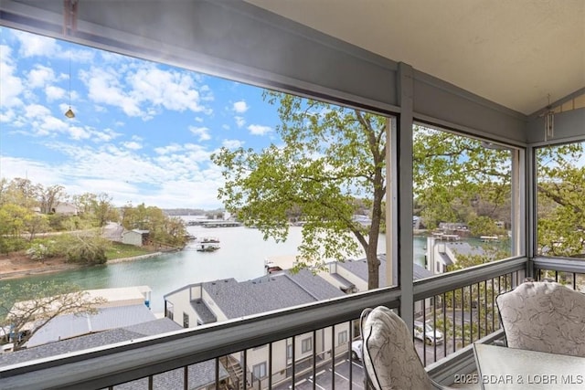 sunroom / solarium with a water view