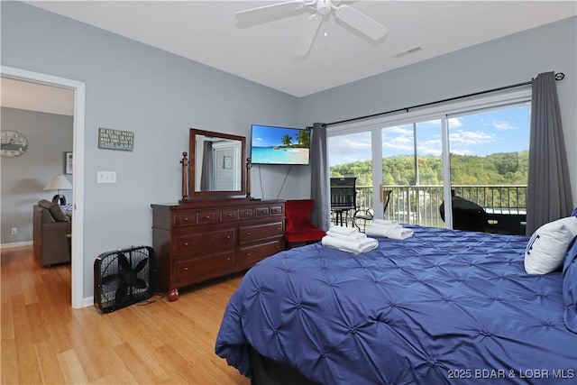 bedroom featuring visible vents, ceiling fan, wood finished floors, access to outside, and baseboards