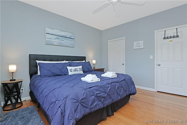 bedroom with ceiling fan, baseboards, and wood finished floors