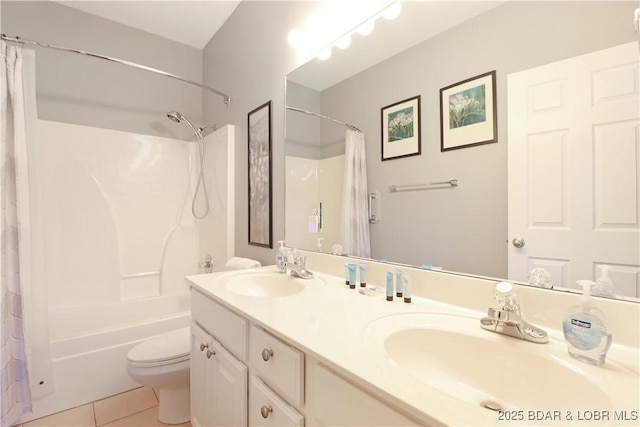 full bath with double vanity, a sink, toilet, and tile patterned floors