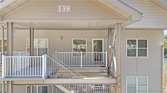 deck with covered porch and stairway