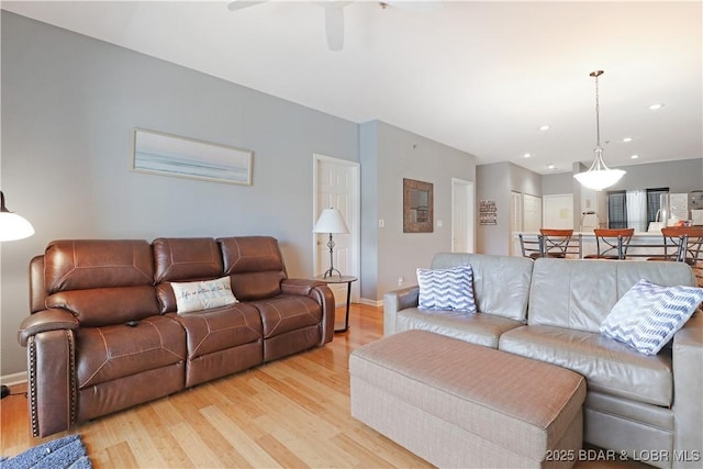 living room with ceiling fan, recessed lighting, baseboards, and light wood-style floors