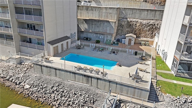 community pool featuring fence and a patio