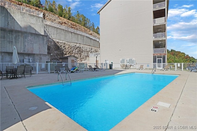 pool featuring a patio and fence