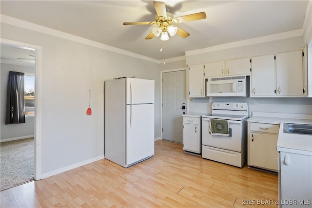 kitchen with light wood-type flooring, white appliances, ornamental molding, and light countertops