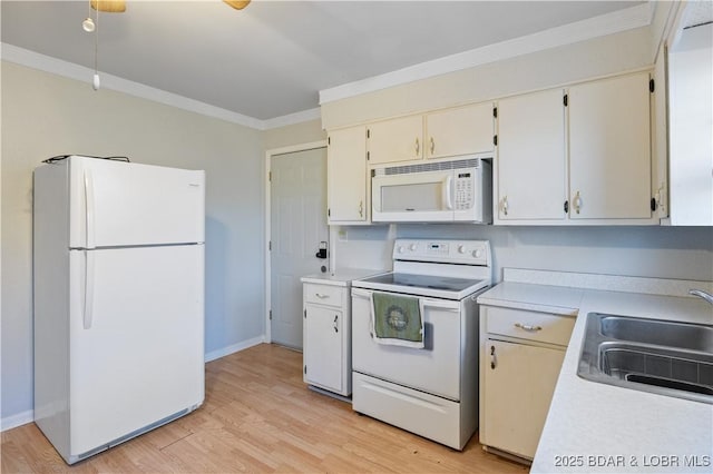 kitchen featuring light countertops, ornamental molding, light wood-style floors, a sink, and white appliances