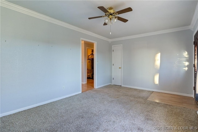 carpeted empty room with ornamental molding, ceiling fan, and baseboards