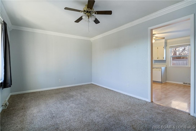 spare room with ornamental molding, light colored carpet, baseboards, and a ceiling fan