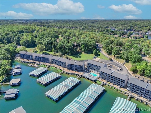 aerial view with a forest view and a water view