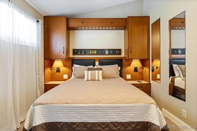 bedroom with lofted ceiling, baseboards, and carpet flooring