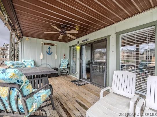 wooden deck featuring a ceiling fan