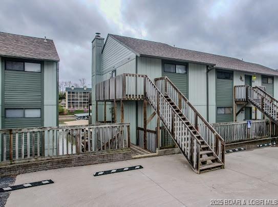 rear view of house with stairs and a patio