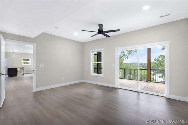 unfurnished room with baseboards, visible vents, ceiling fan, dark wood-style flooring, and recessed lighting