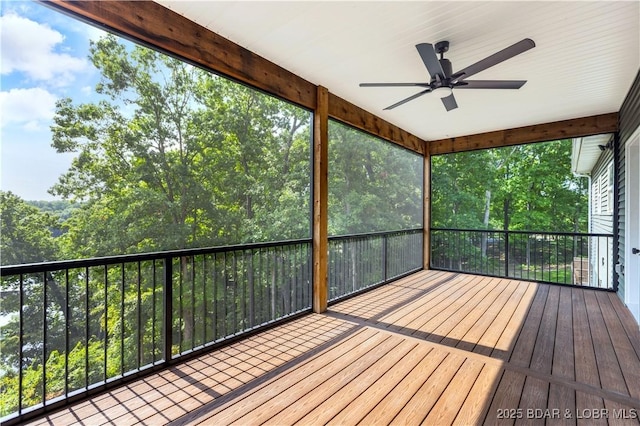 unfurnished sunroom featuring ceiling fan and a wealth of natural light