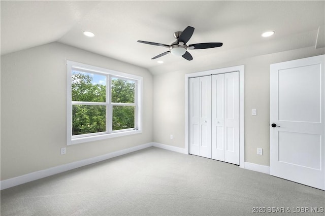 unfurnished bedroom with carpet, baseboards, vaulted ceiling, and recessed lighting