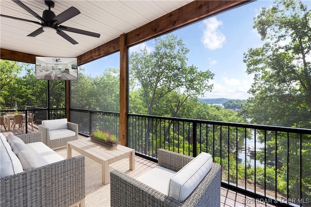 wooden deck featuring outdoor dining area, outdoor lounge area, and ceiling fan