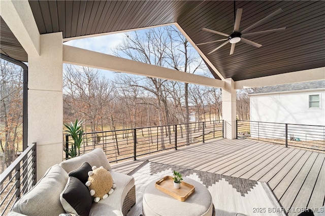 deck with outdoor lounge area and a ceiling fan