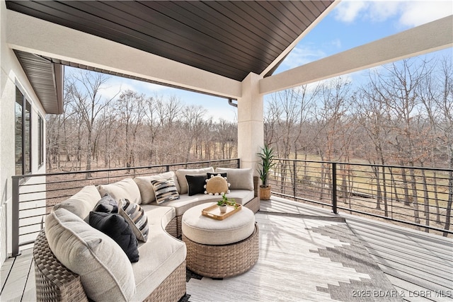 wooden terrace with an outdoor hangout area