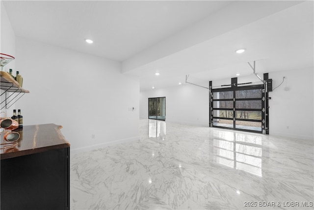 interior space featuring recessed lighting, marble finish floor, and baseboards