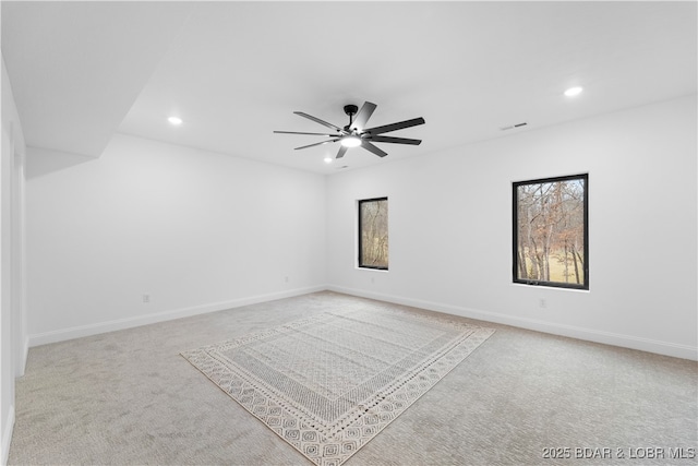 carpeted empty room with recessed lighting, a ceiling fan, and baseboards