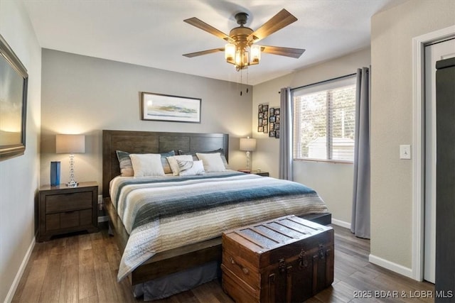 bedroom featuring wood finished floors, a ceiling fan, and baseboards