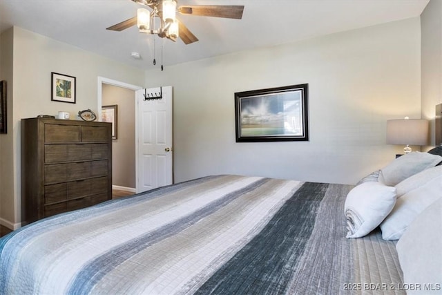 bedroom with a ceiling fan and baseboards