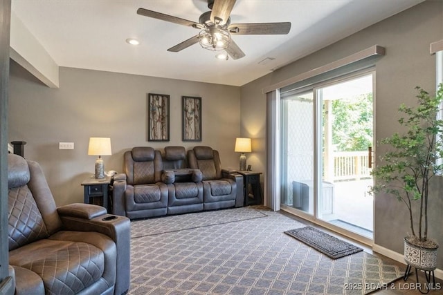 carpeted living room with a ceiling fan