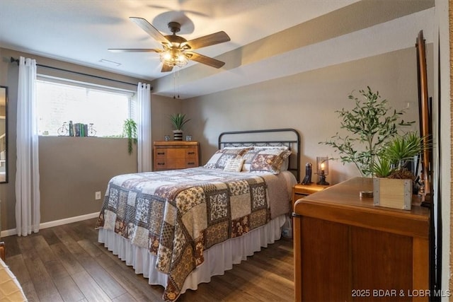 bedroom featuring a ceiling fan, baseboards, and wood finished floors