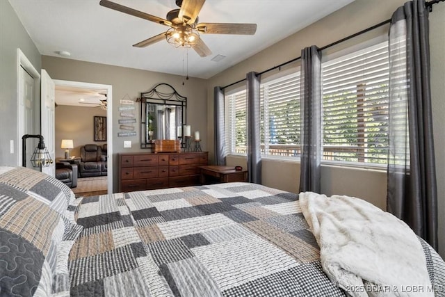 bedroom with a ceiling fan, multiple windows, and visible vents